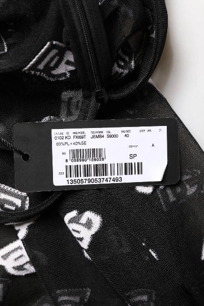 Close-up of a black and white patterned garment with a label on a white background