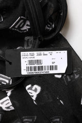 Close-up of a black and white patterned garment with a label on a white background