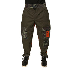 Green tactical pants with camouflage and orange patches on a white background