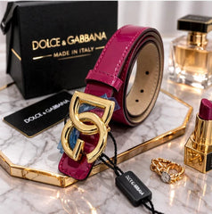 Dolce & Gabbana belt with packaging and accessories on a white background
