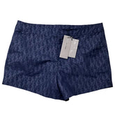 Blue shorts with a pattern and tags on a white background