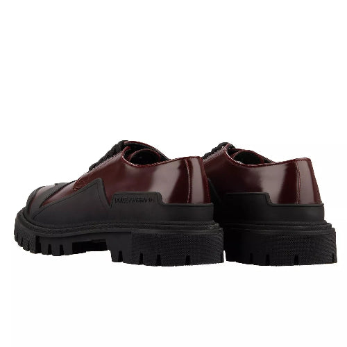 Pair of brown shoes with thick black soles on a white background