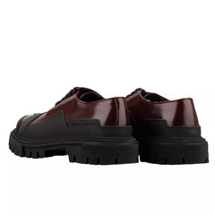 Pair of brown shoes with thick black soles on a white background