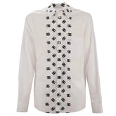 White shirt with black geometric pattern on buttons against a white background