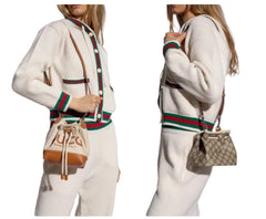 Two people wearing white sweaters with brown leather bags on a white background