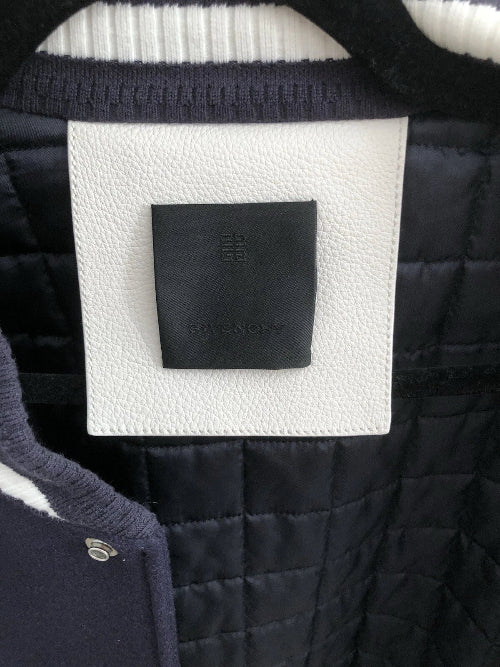 Close-up of a Givenchy logo patch on a quilted jacket
