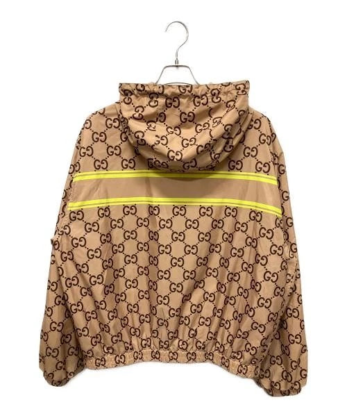 Beige jacket with Gucci logo pattern on a white background