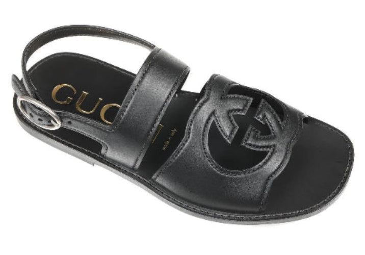 Black sandal with Gucci logo on a white background