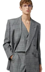 Person wearing a gray checkered suit with a plain background