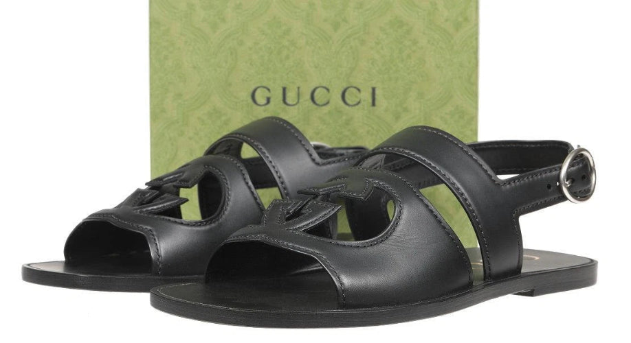 Black sandals with Gucci box in the background