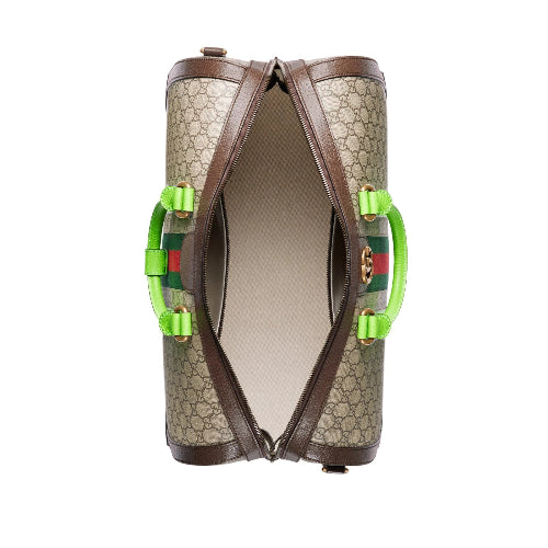 Designer handbag with green accents on a white background