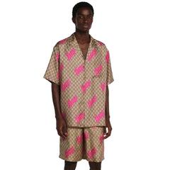 Person wearing a patterned shirt and shorts set on a plain background