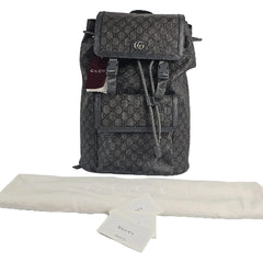 Gray Gucci backpack with a tag on a light gray background