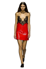 Model walking on a runway wearing a red dress with a black lace top.