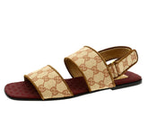 Beige sandal with patterned straps on a white background