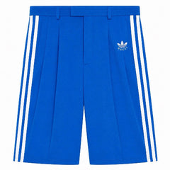 Blue shorts with white stripes and Adidas logo on a white background