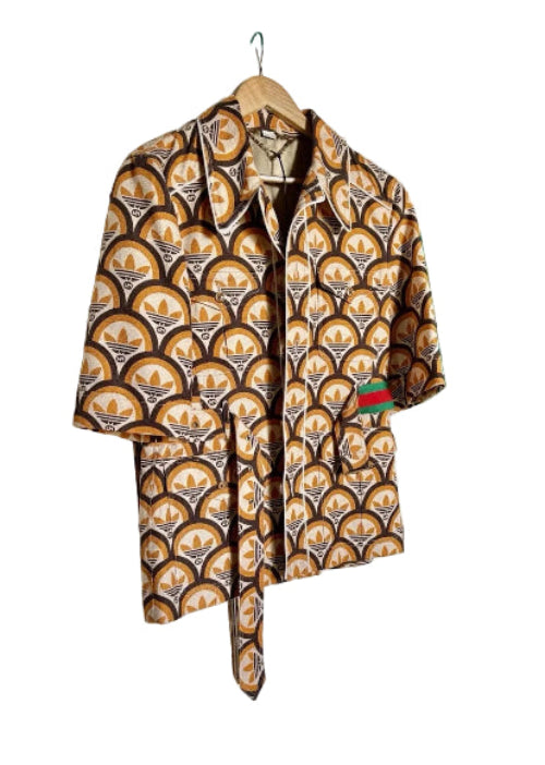 Brown leather jacket hanging on a white door with a green wall background