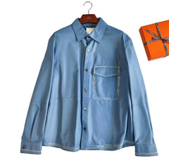 Blue shirt on a hanger with an orange box in the background