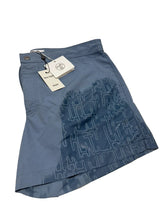 Blue denim fabric with a label on a white background