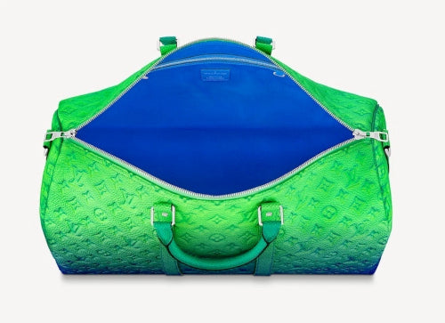 Green and blue duffel bag with a visible brand logo on a white background