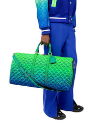 Person holding a green and blue gradient duffel bag against a white background
