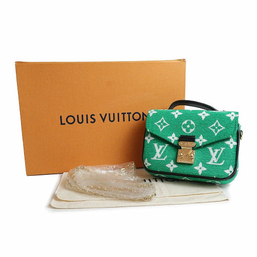 Green Louis Vuitton handbag with monogram pattern, box, and dust bag on a white background