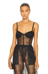 Model wearing a black lace lingerie set on a white background