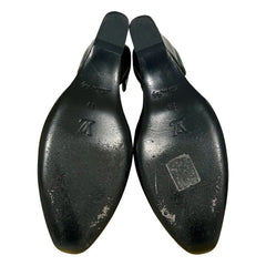 A pair of black leather shoe lasts or wooden shoe trees with a glossy finish, showing the embossed Louis Vuitton 'LV' logo and size markings on the bottom sole, set against a plain white background.