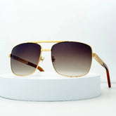 Gold-framed sunglasses with gradient lenses on a white background
