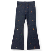 Dark blue jeans with embroidered logos on a white background