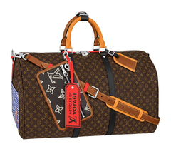 Louis Vuitton monogram duffle bag in brown coated canvas with tan leather handles and trim, black shoulder strap, silver hardware, and a red luggage tag reading 'ARTICLES DE VOYAGE'.
