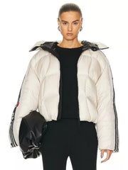 Person wearing a white puffer jacket with black accents on a white background
