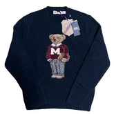 Navy blue sweater with a bear graphic and Polo Ralph Lauren tag on a textured white background