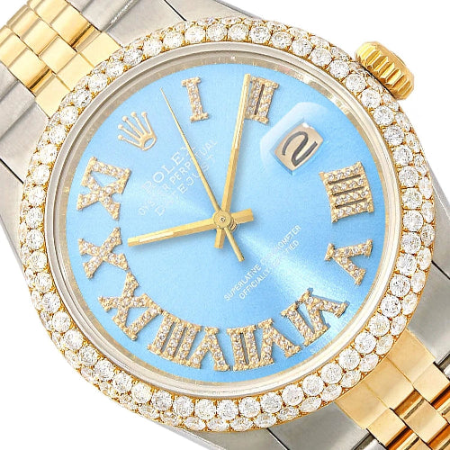 Luxury watch with gold and silver case, blue face, and Roman numeral markers.