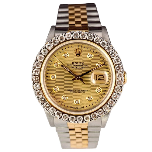 Gold watch with diamond-studded bezel on a white background