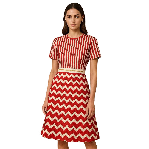 Woman wearing a red and white striped top and chevron pattern skirt on a beige background