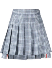A pleated plaid mini skirt in gray, white, and light blue, featuring a signature red, white, and blue stripe detail along the hem.