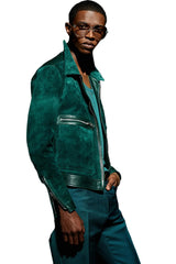 Man wearing a green suede jacket and pants against a black background