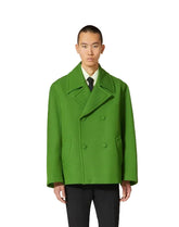 Man wearing a bright green coat on a white background