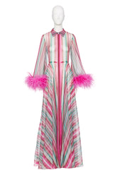 A long-sleeved maxi dress with vertical pink, mint green, and white stripes, featuring bright pink feather trim at the cuffs and a matching striped bow at the collar, displayed on a white mannequin.