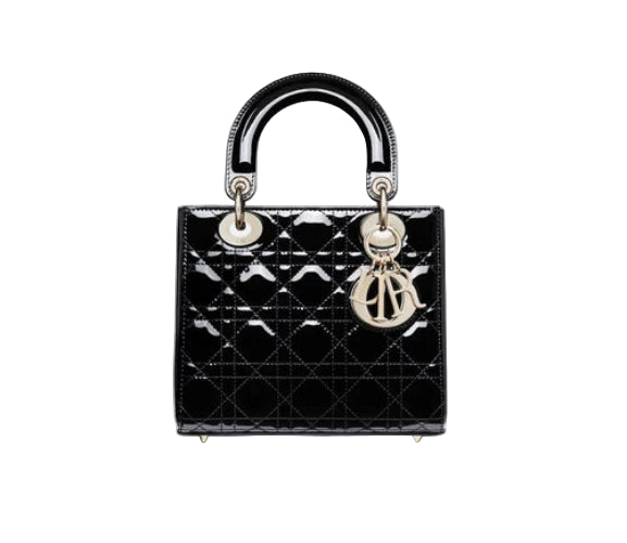 Black quilted handbag with gold hardware on a light gray background
