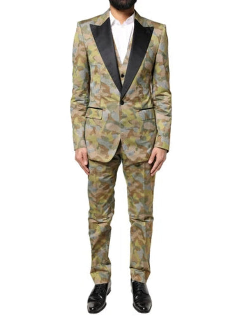A model wearing a Dolce & Gabbana multicolor camouflage three-piece suit, with a white shirt and black shoes.