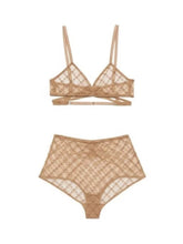 Beige lace lingerie set on a white background