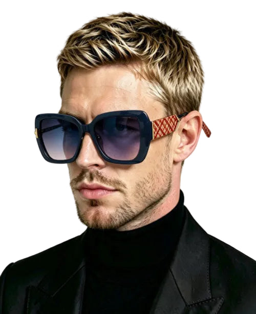 A close-up portrait of a man wearing oversized square sunglasses with dark blue lenses and patterned orange-red temple arms, paired with a black turtleneck and jacket against a light gray background.