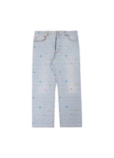 Light blue denim jeans with an all-over repeating monogram pattern and small scattered multicolor embroidered accents, laid flat against a light beige background.