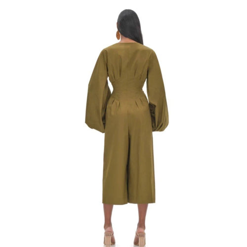 Woman wearing a green jumpsuit on a white background