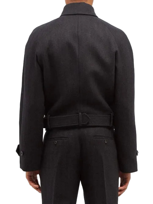 Rear view of a model wearing a dark charcoal gray belted jacket and matching trousers against a plain white background.