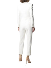 Person wearing a white long-sleeve dress against a white background