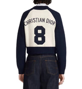 Navy and white sweater with 'Christian Dior' and number '8' on the back, worn by a person.