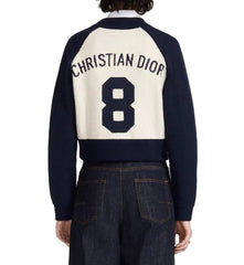 Navy and white sweater with 'Christian Dior' and number '8' on the back, worn by a person.